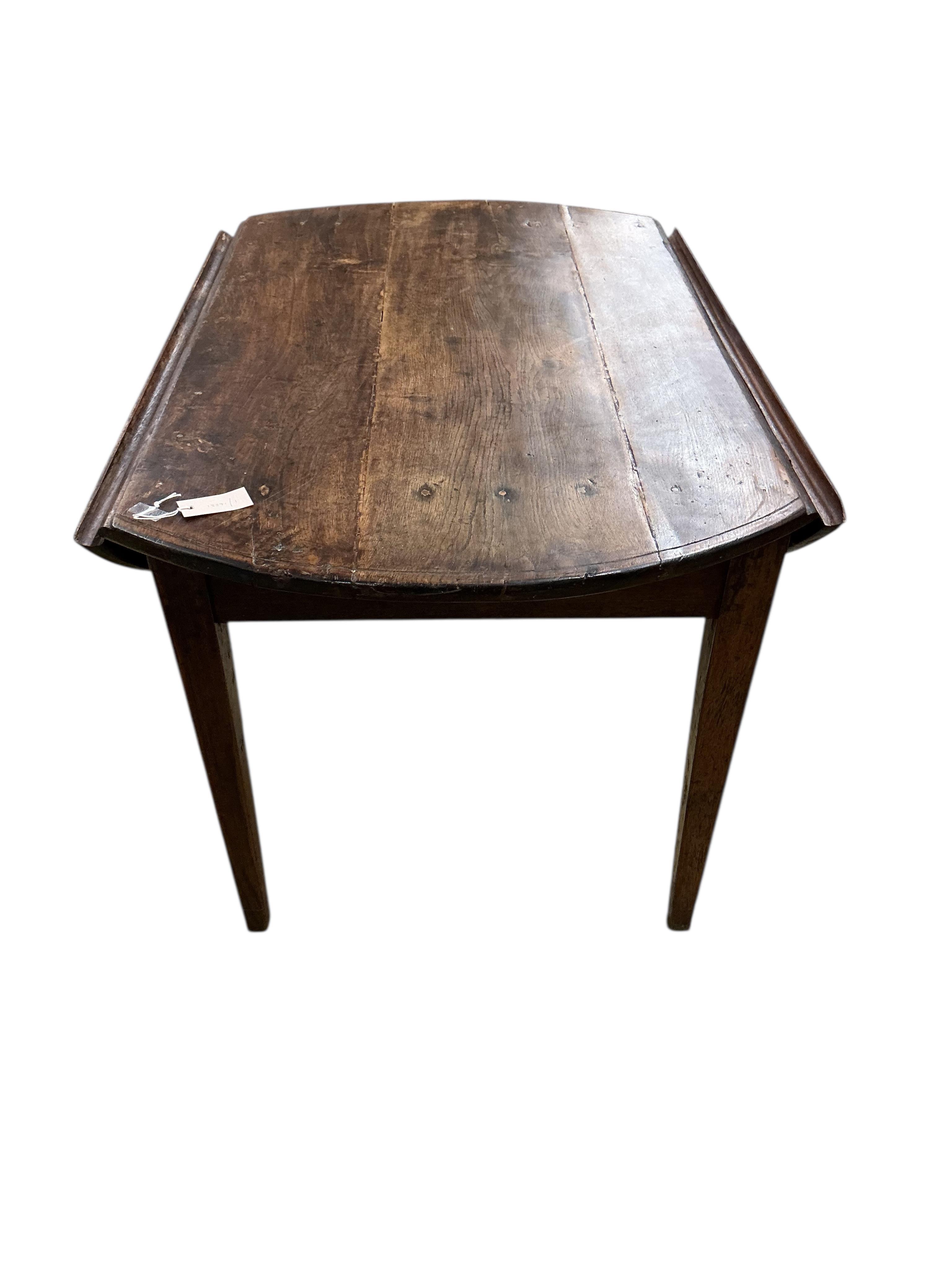 A 19th century French Provincial oak drop leaf table, width 122cm, depth 79cm, height 71cm